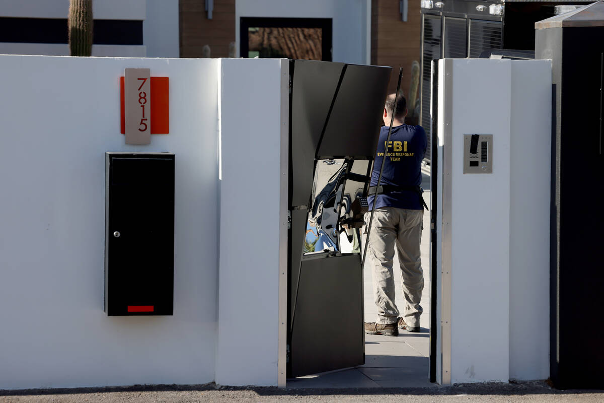 FBI personnel investigate at a home on the corner of West La Madre Way and Conough Lane in Las ...