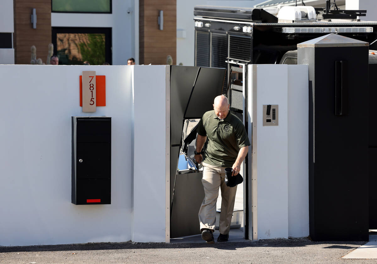 FBI personnel investigate at a home on the corner of West La Madre Way and Conough Lane in Las ...