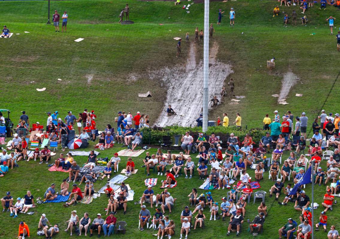 Fans watch a baseball game on the hillside overlooking Howard J. Lamade Stadium during the Litt ...