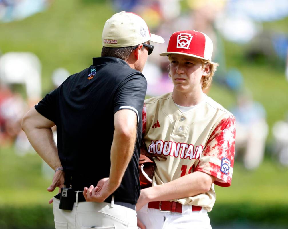 The Henderson All-Stars pitcher Nolan Gifford discusses with team manager Ryan Gifford on the m ...