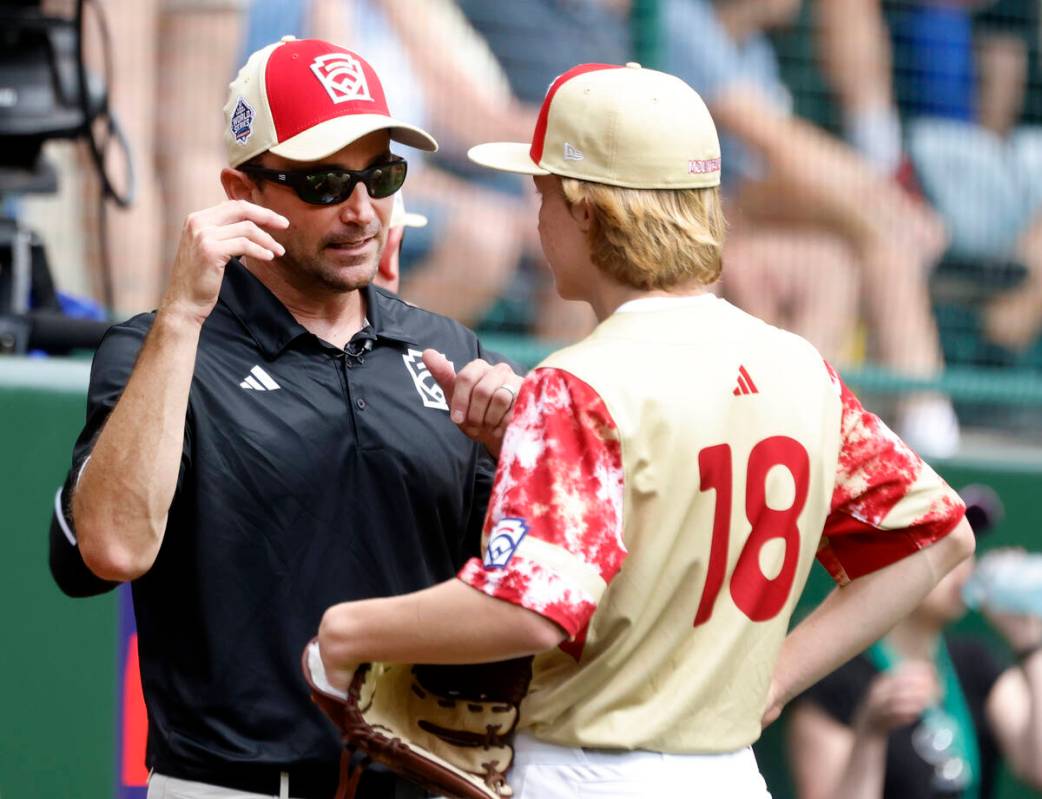 The Henderson All-Stars pitcher Nolan Gifford discusses with team manager Ryan Gifford during t ...