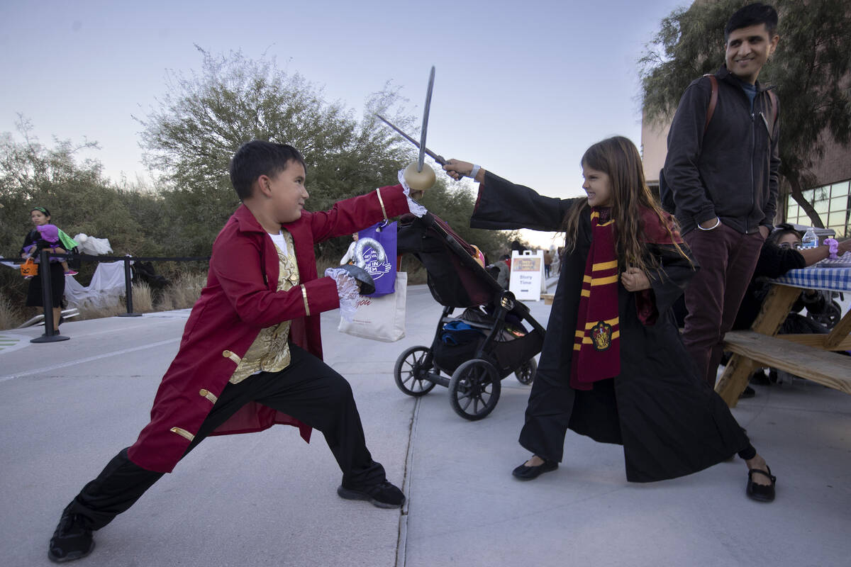 Mason Freitas, 7, left, and Suraya Freitas, 7, right, have a sword versus wand fight during the ...