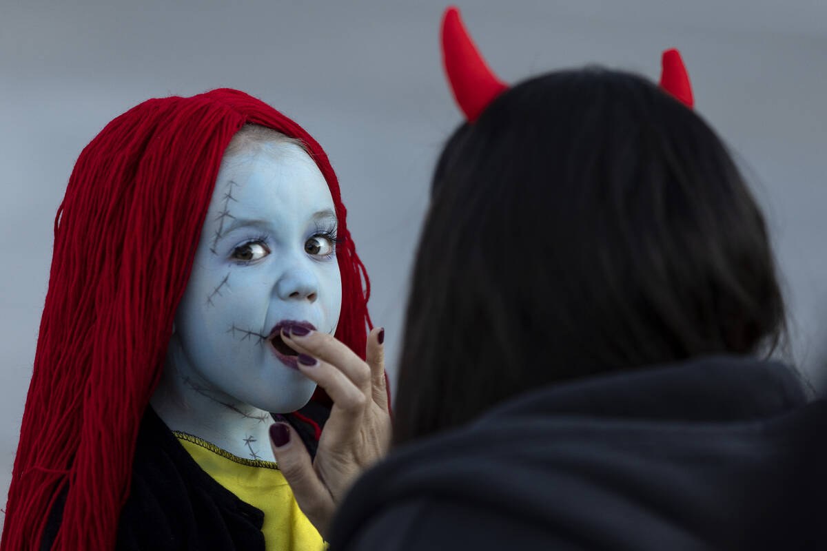 Alexandria Guzman fixes the makeup of Storm Iacuaniello, 5, dressed as Sally from The Nightmare ...