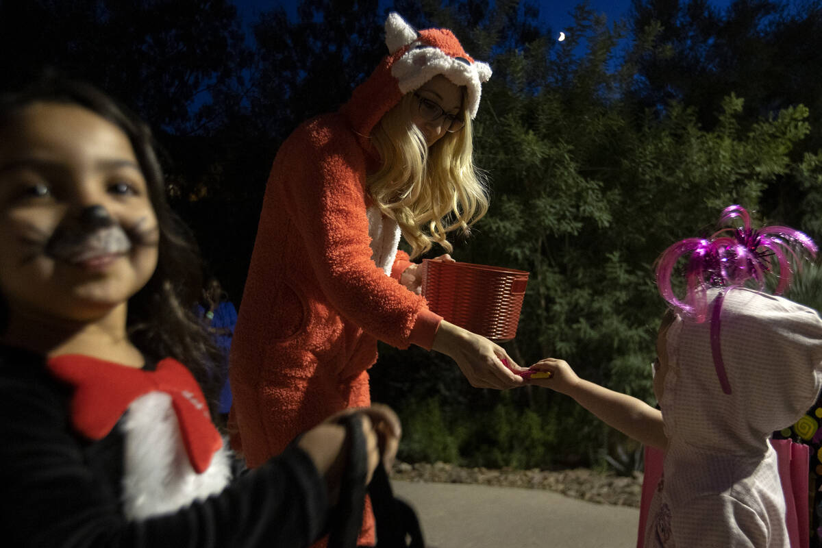 Trick-or-treaters work for their candy during the Haunted Harvest Halloween event at Springs Pr ...