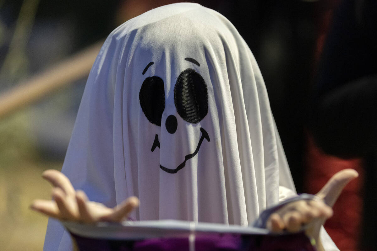 A ghost trick-or-treats during the Haunted Harvest Halloween event at Springs Preserve on Satur ...