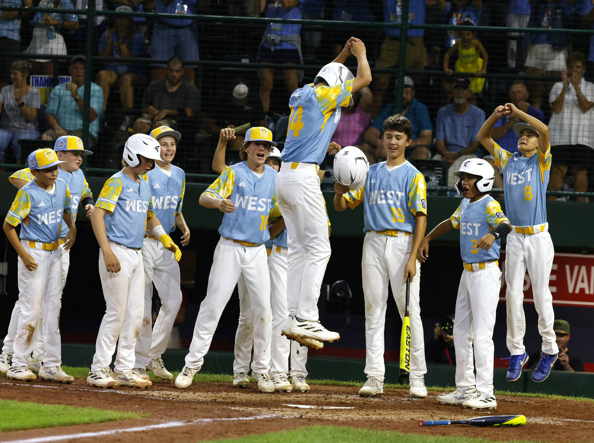 El Segundo, California All-Stars shortstop Brody Brooks congratulated by his teammates after hi ...