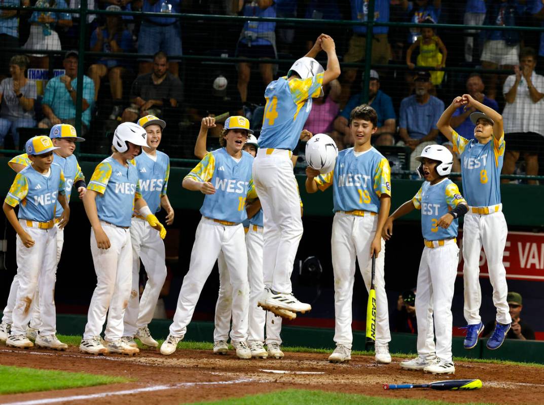 El Segundo, California All-Stars shortstop Brody Brooks congratulated by his teammates after hi ...