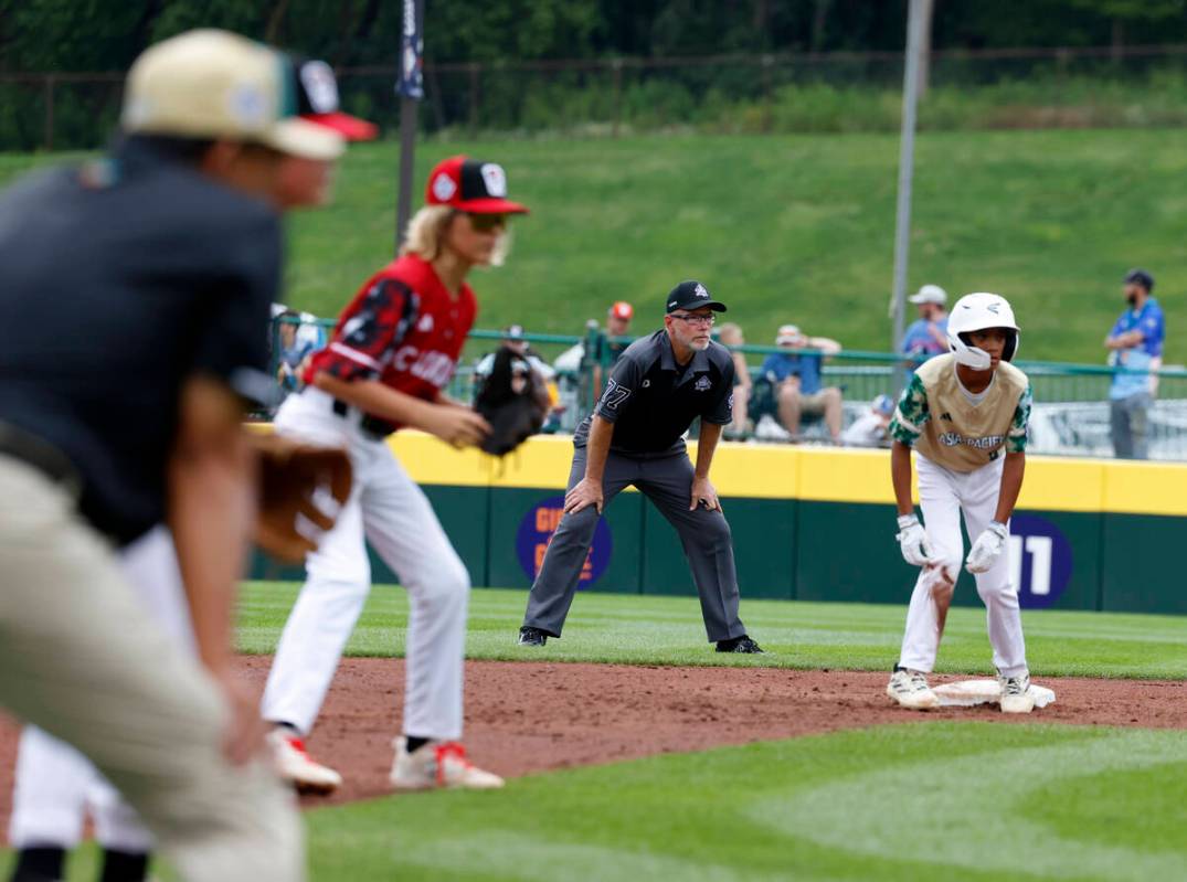 Second base umpire Ben Sprague of Las Vegas, second right, watches play during the Little Leagu ...