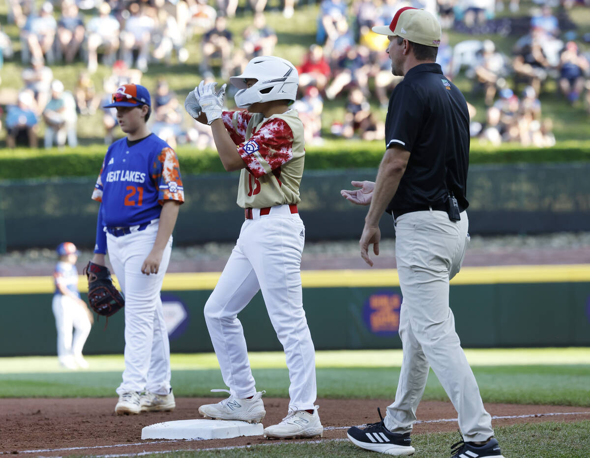 The Henderson All-Stars pitcher David Edwards reacts after hitting a single as New Albany, Ohio ...