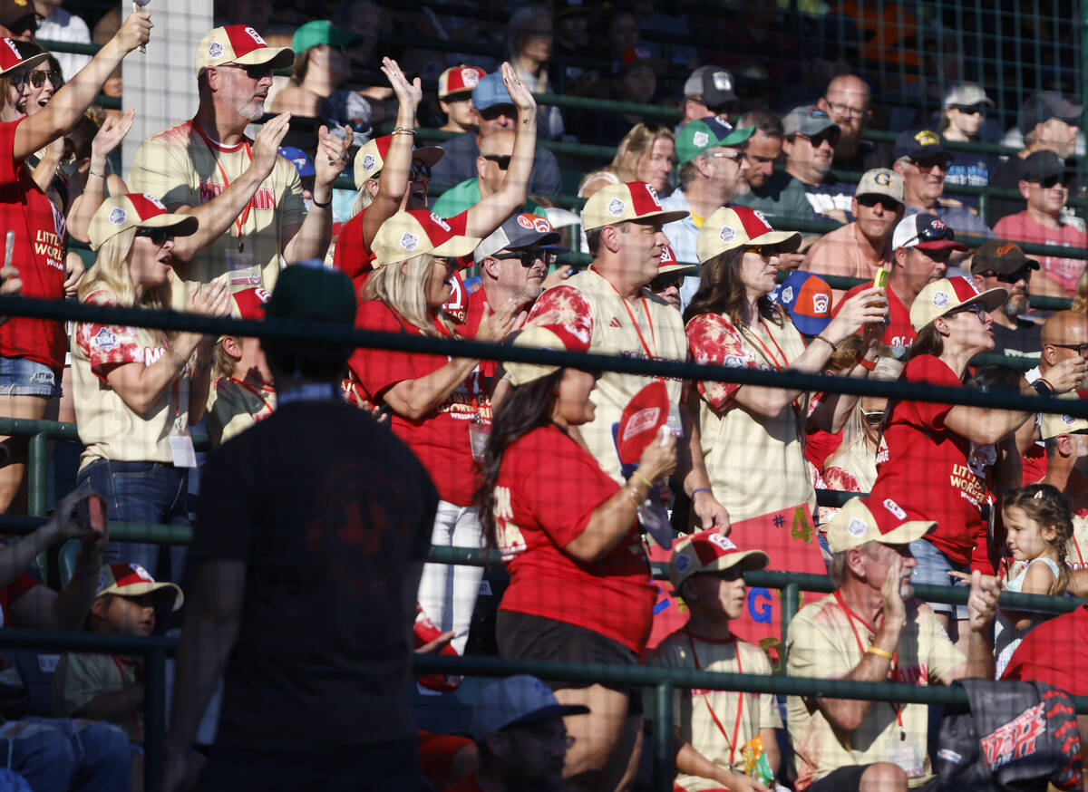 The Henderson All-Stars fans and parents who traveled from Henderson cheer for their team durin ...