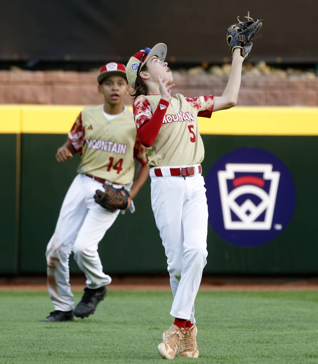 The Henderson All-Stars left fielder Liam Wells (5) catches the ball as centerfielder JoJo Dixo ...