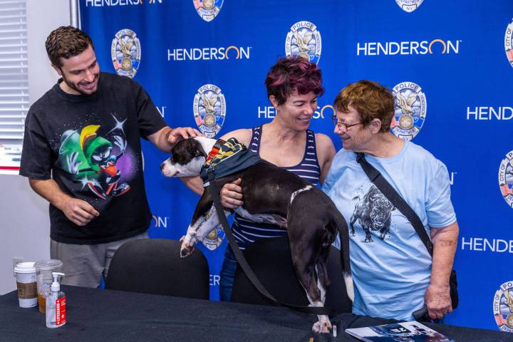 (From left) Golden Knights forward Gage Quinney greets dog Ashley Benton with fans Tina Rodilos ...