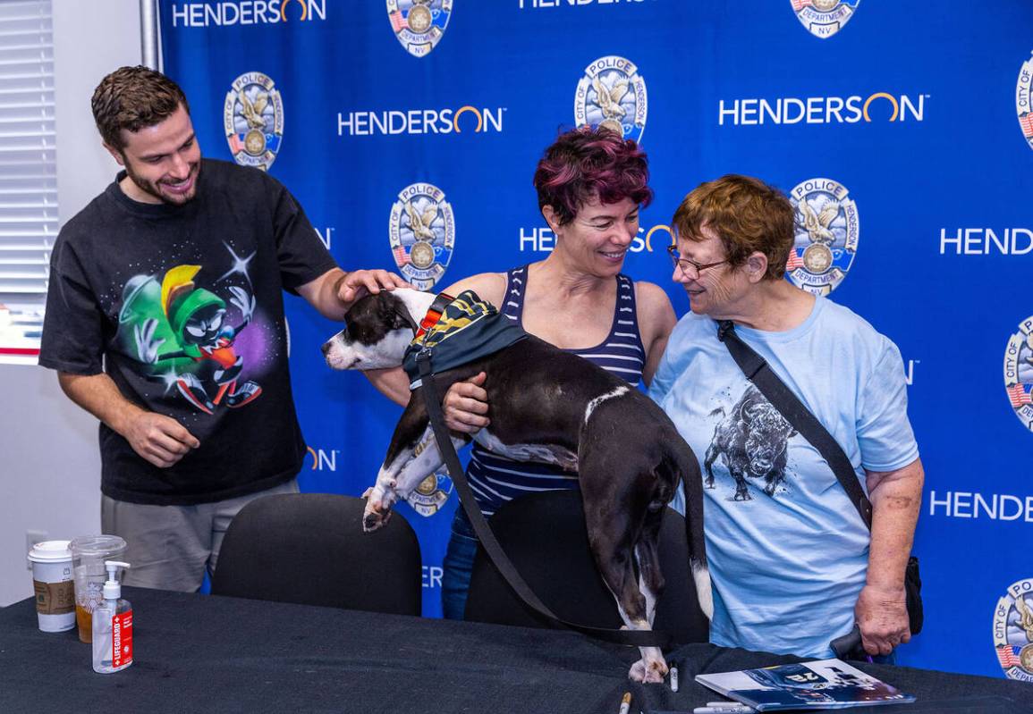 (From left) Golden Knights forward Gage Quinney greets dog Ashley Benton with fans Tina Rodilos ...