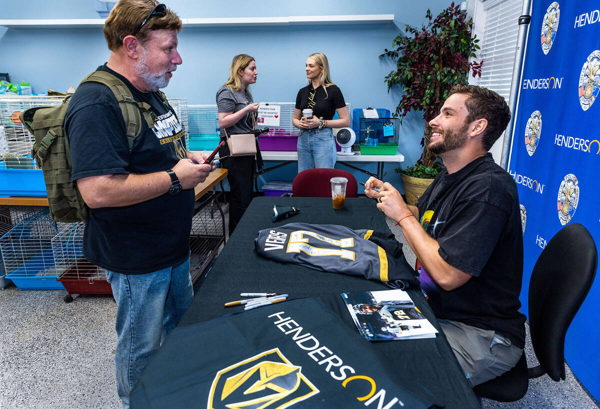 Golden Knights forward Gage Quinney, right, talks with fan Tom Perkins during a meet and greet ...