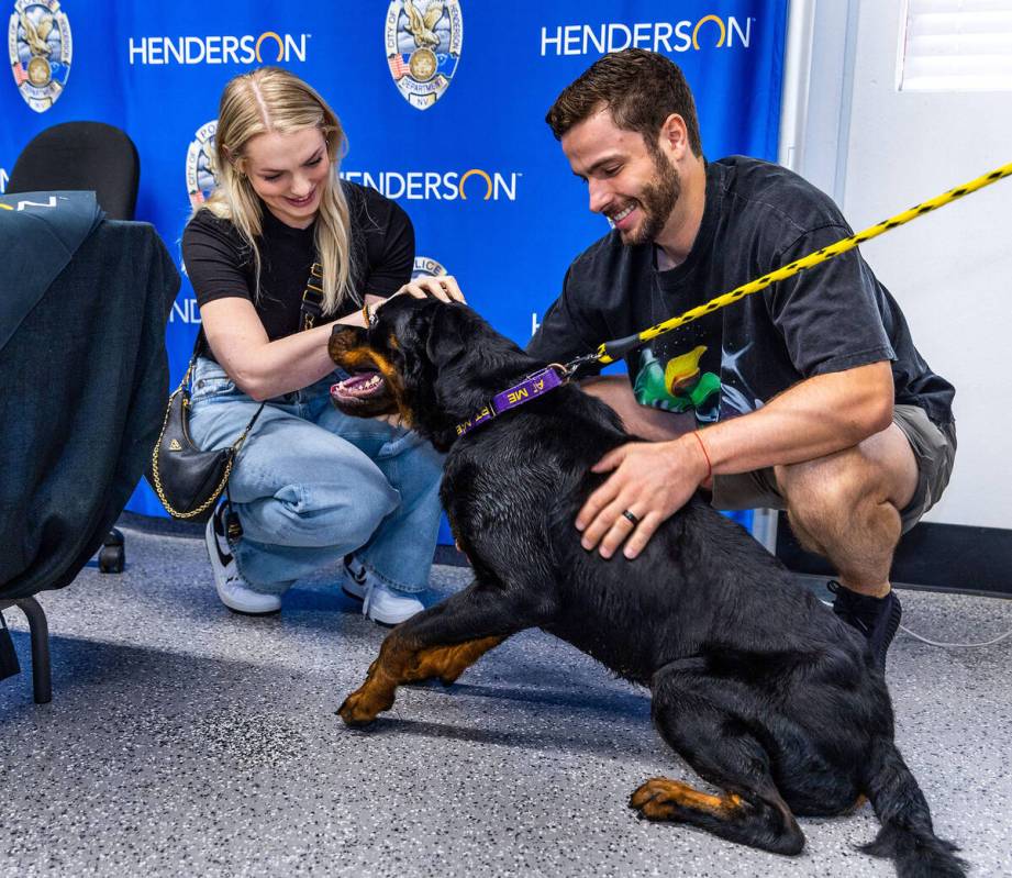 Golden Knights forward Gage Quinney, right, and his wife Ashley get to know Gage the dog up for ...