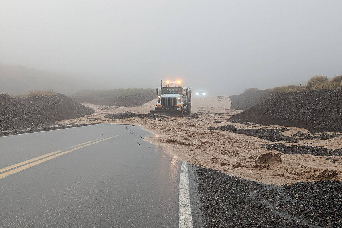 Rocks, mud and floodwater being cleared from highway 190 after heavy rains hit Death Valley Nat ...