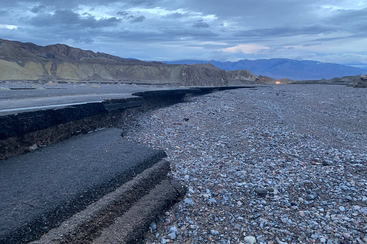 Floodwaters carrying rocks undercut pavement along CA-190 east of Furnace Creek. Photo taken th ...