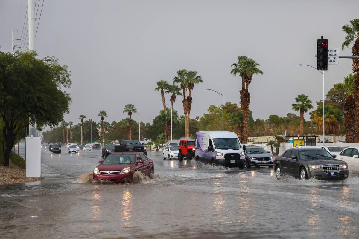 Cars battle rush hour traffic amidst a flash flood warning along Eastern Ave and Robindale Road ...