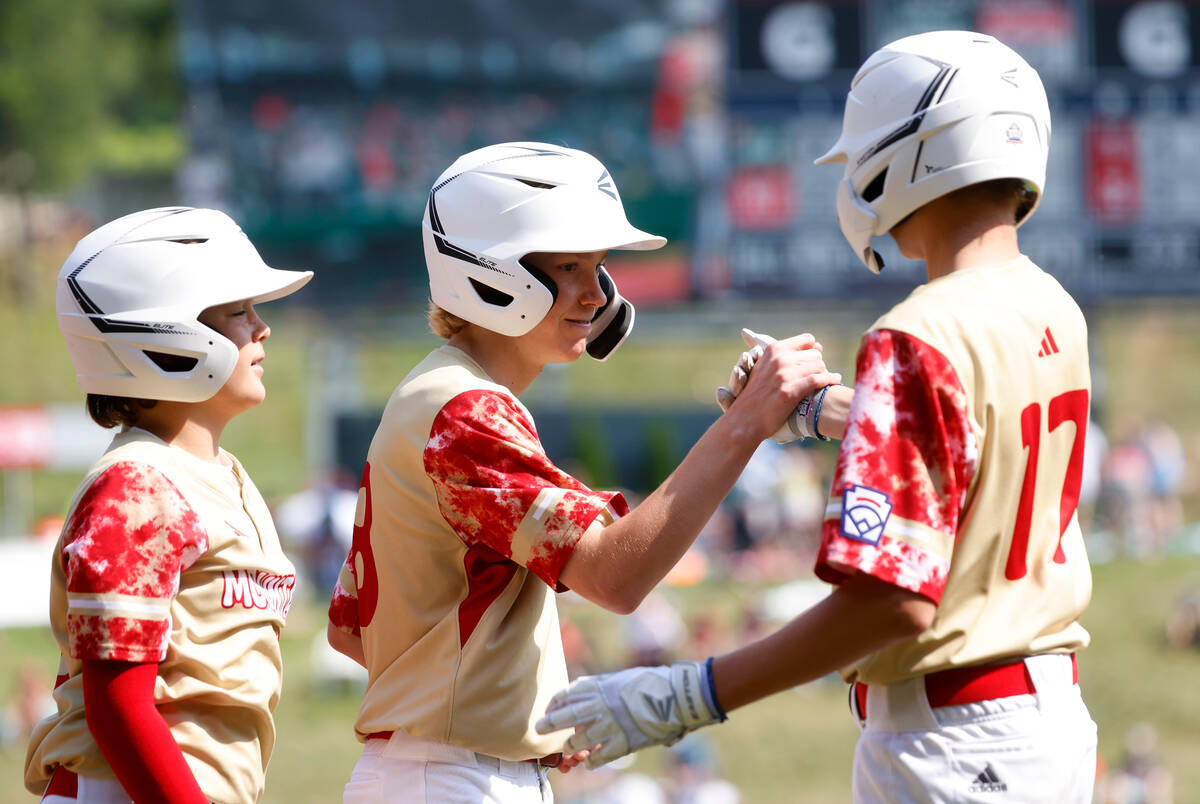 The Henderson All-Stars centerfield Nolan Gifford, center, celebrates with his teammates after ...