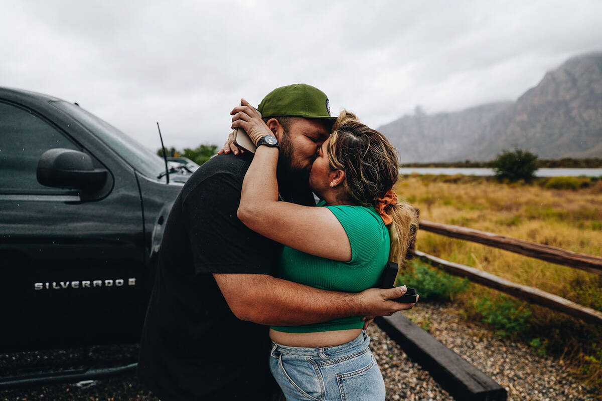 Eddie Hernandez, left, kisses his fiancé, Janette Espejo, after proposing to her while at ...