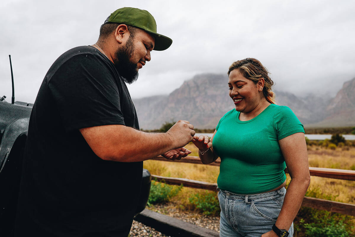 Eddie Hernandez, left, puts an engagement ring on Janette Espejo’s finger after proposin ...