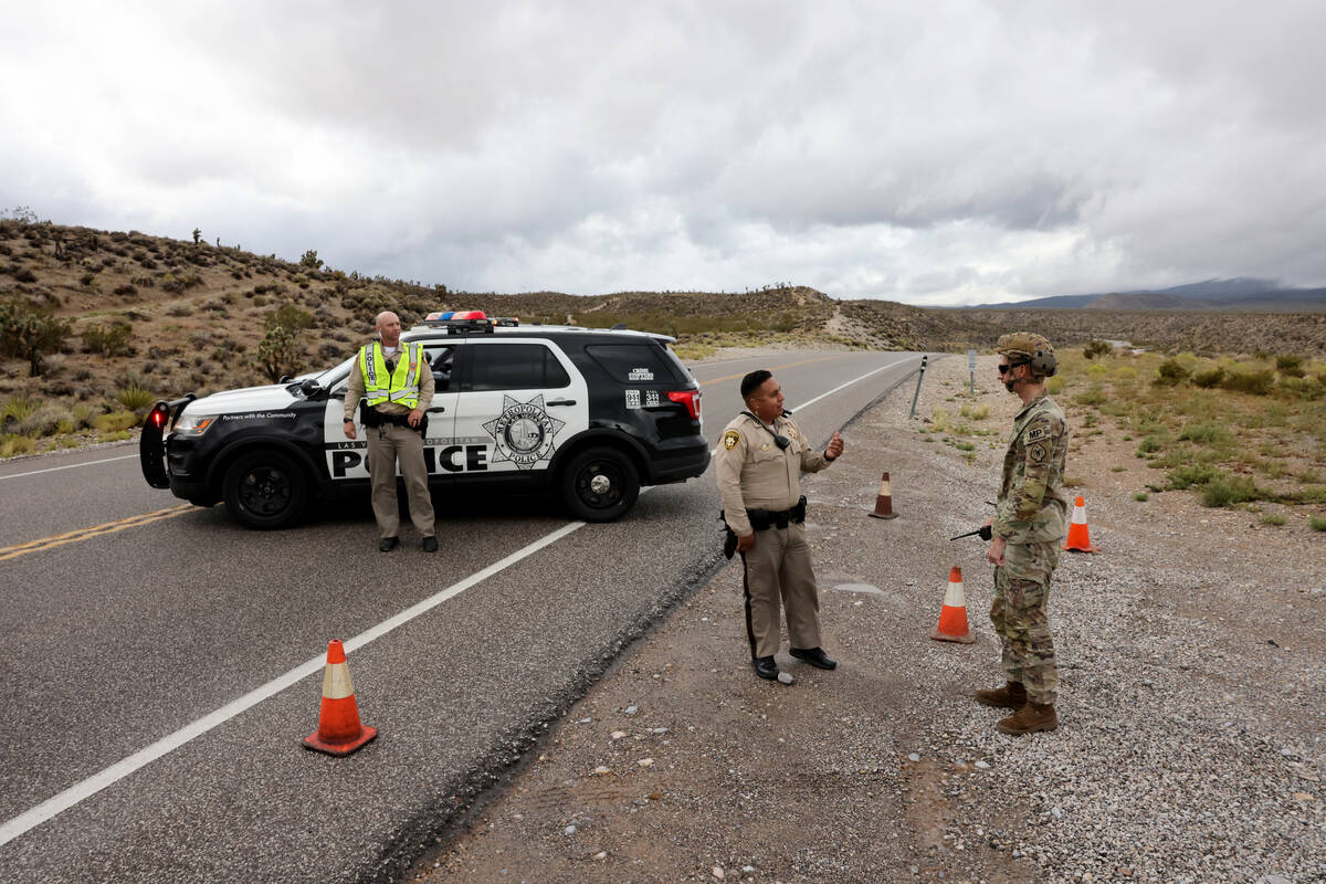 Nevada National Guard Military Police Sgt. Holsten, from right and Las Vegas police officers I. ...