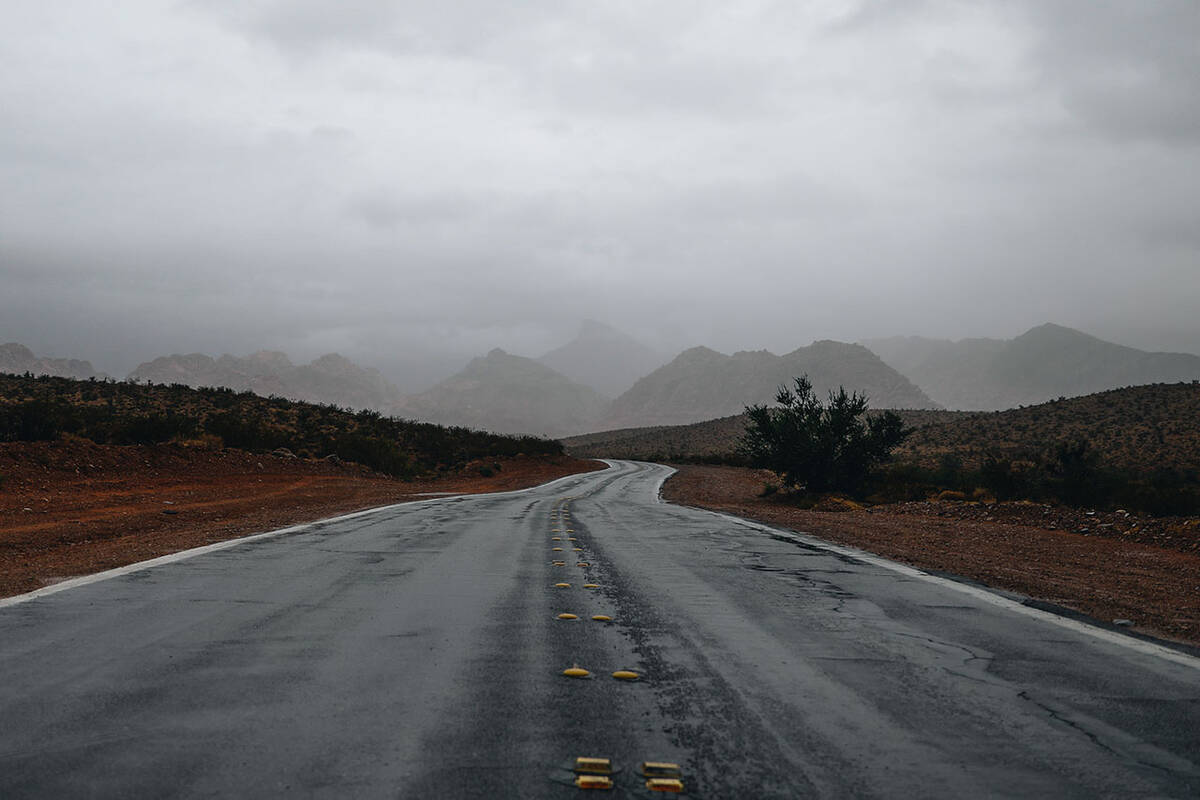 Fog and rain from storms developed by Hurricane Hilary are seen in the mountains outside of Red ...