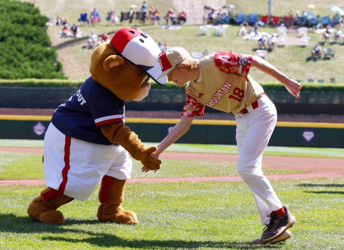 The Henderson All-Stars pitcher Nolan Gifford is greeted by Dugout, the official mascot of Litt ...