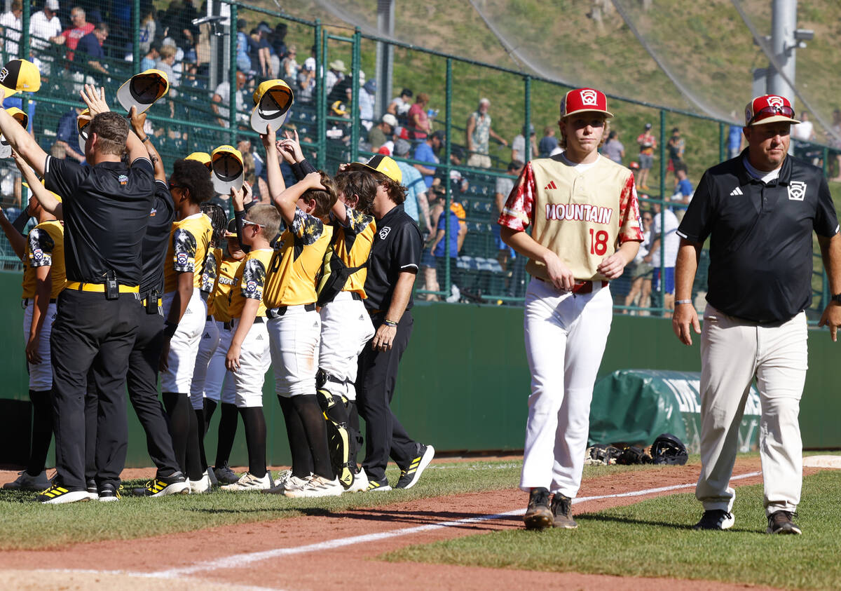 The Henderson All-Stars pitcher Nolan Gifford and assistant coach Chris Petty leave the field a ...