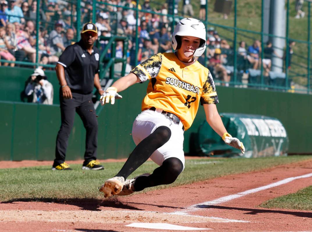 Nolensville, Tennessee, designated hitter Stella Weaver beats a throw and scores against Hender ...