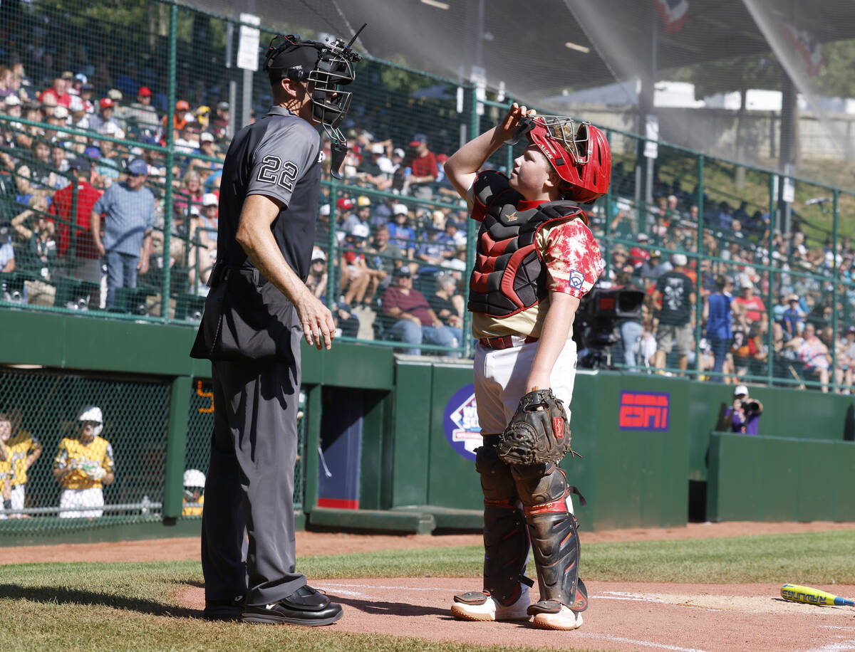 The Henderson All-Stars catcher Arlie Daniel IV reacts to the home plate umpire Dave Miller's c ...