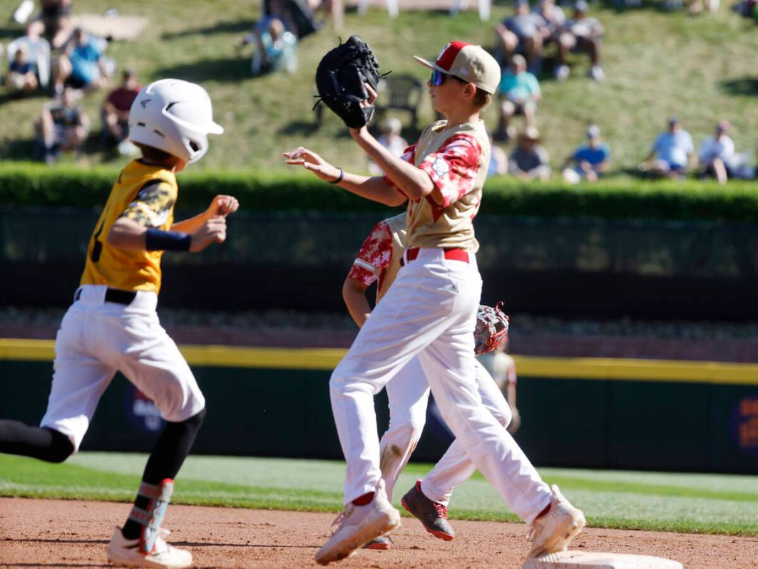 Nolensville, Tennessee, centerfield Grayson May is forced out by Henderson All-Stars first base ...