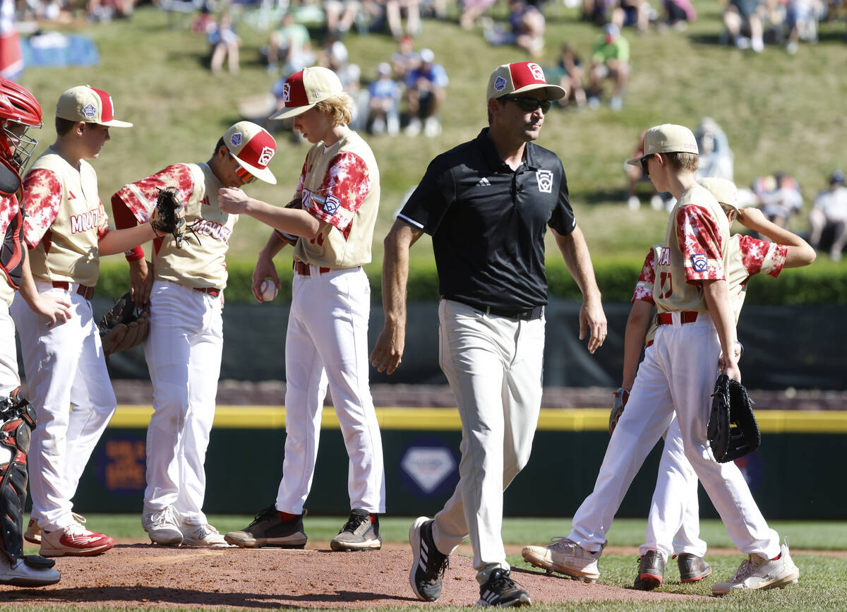 The Henderson All-Stars manager Ryan Gifford leaves the mound after talking with starting pitch ...