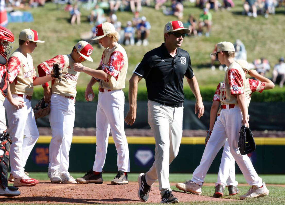 The Henderson All-Stars manager Ryan Gifford leaves the mound after talking with starting pitch ...