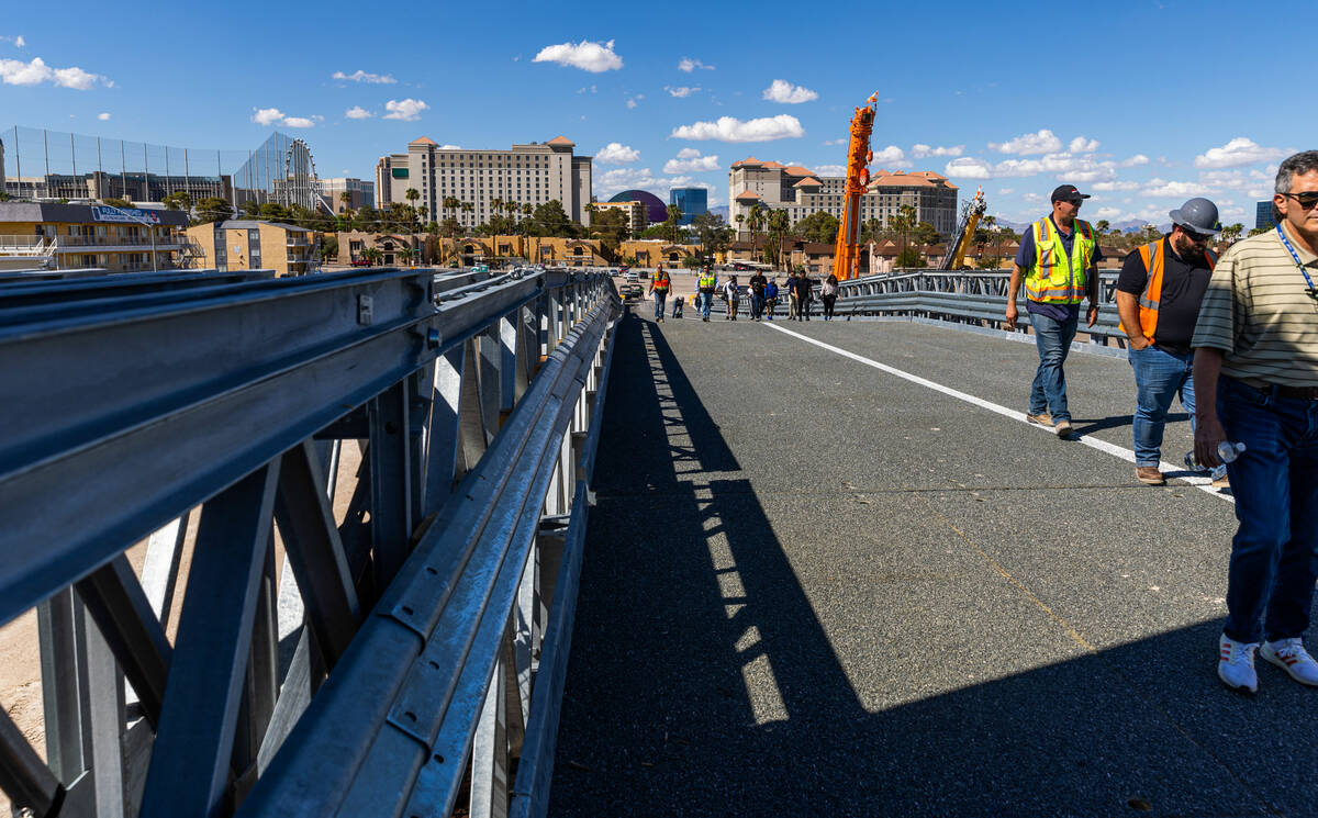 Members of the media walk across a span as the Las Vegas Grand Prix, Inc. gives a preview of th ...