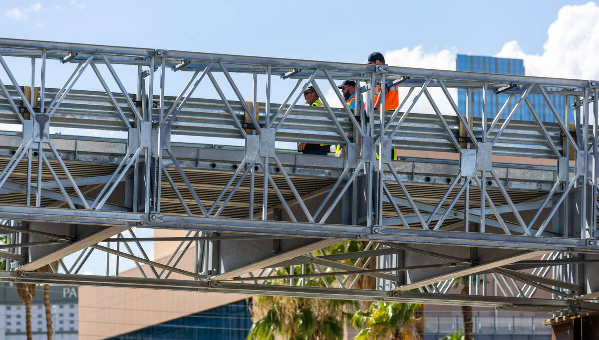 Workers walk across as the Las Vegas Grand Prix, Inc. gives a preview of the temporary vehicula ...