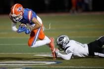 Bishop Gorman High School's Audric Harris (17) carries a ball as Palo Verde High School's Dupar ...