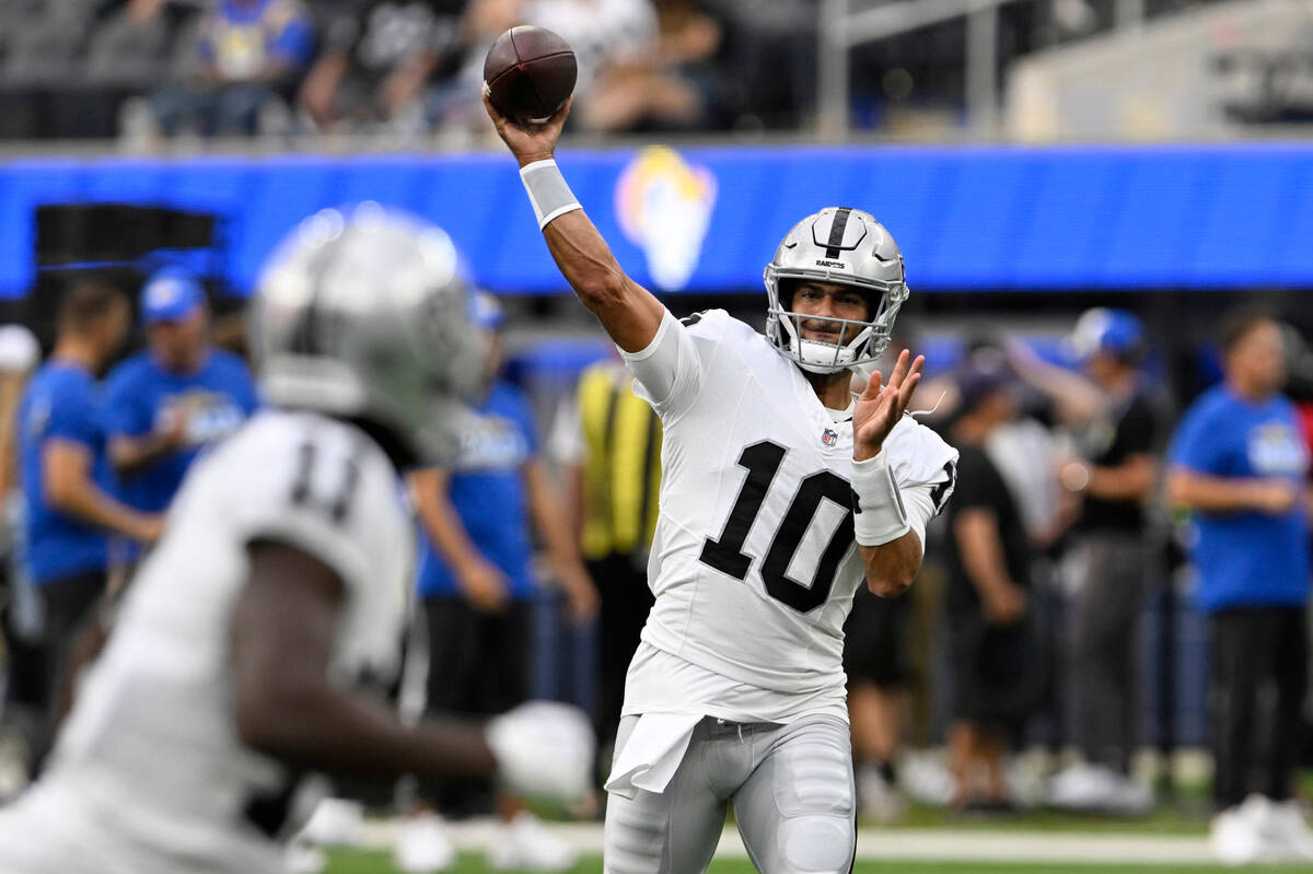 Las Vegas Raiders quarterback Jimmy Garoppolo warms up before a preseason NFL football game aga ...