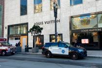 FILE - Police officers and emergency crews park outside the Louis Vuitton store in San Francisc ...