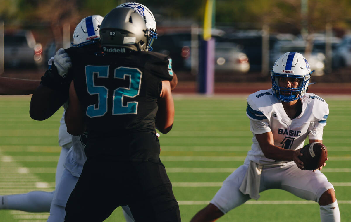 Basic quarterback Anthony Vega (1) looks to pass the ball to a teammate during a game against S ...