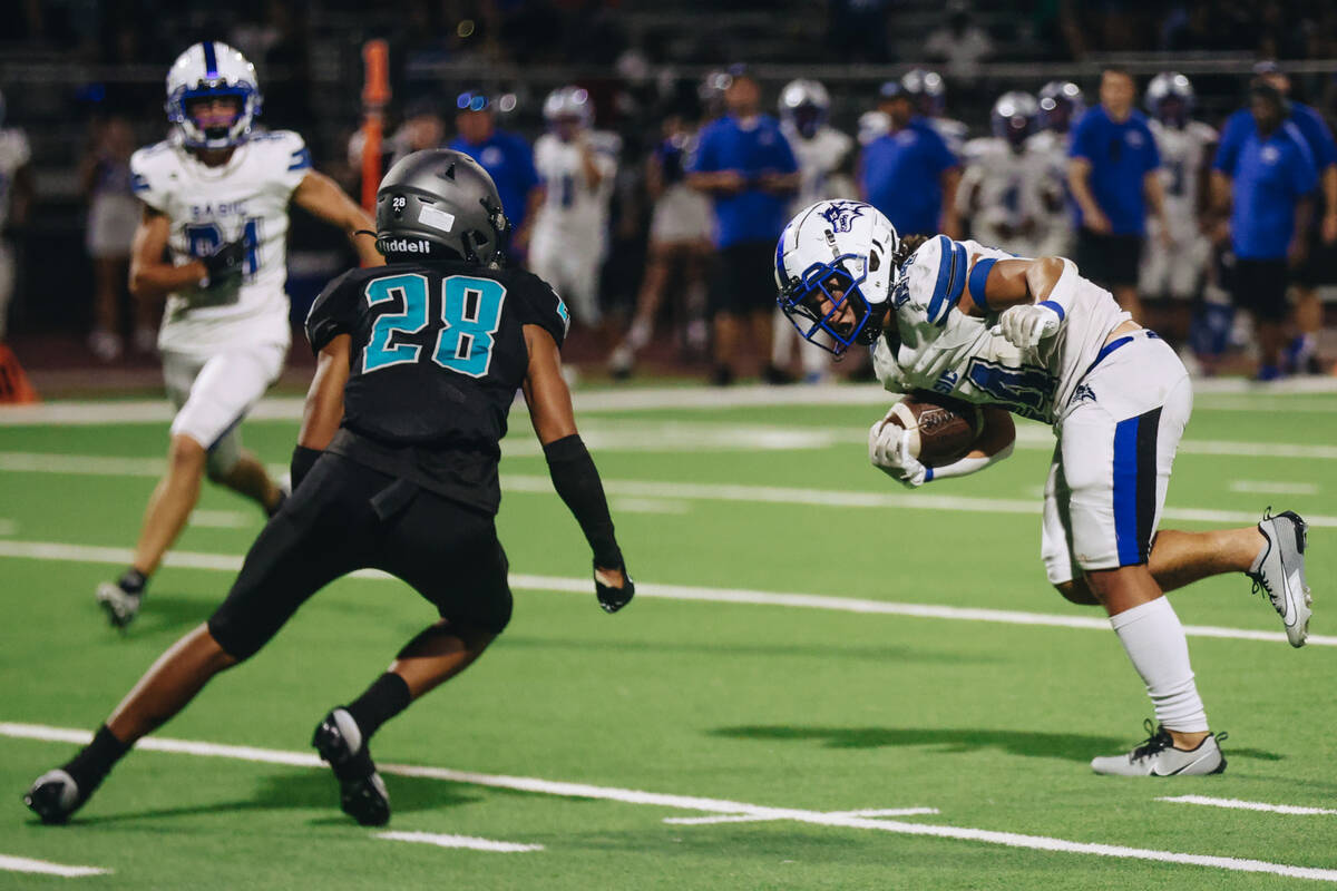 Basic running back Boston Wren (24) dodges Silverado wide receiver Ian-Jmes Ioane (28) during a ...