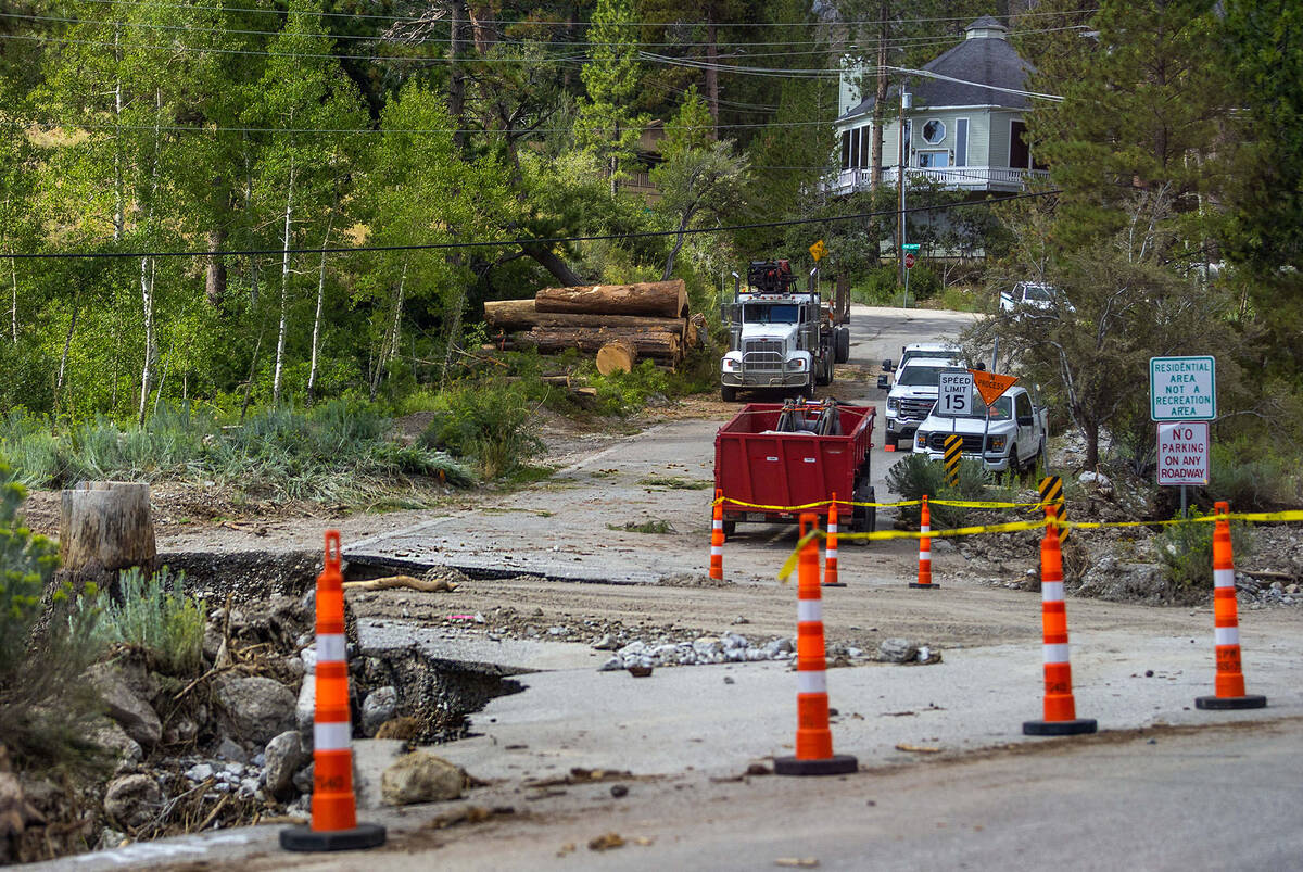 The road leading into the Rainbow subdivision is severely impacted in Kyle Canyon as cleanup fr ...