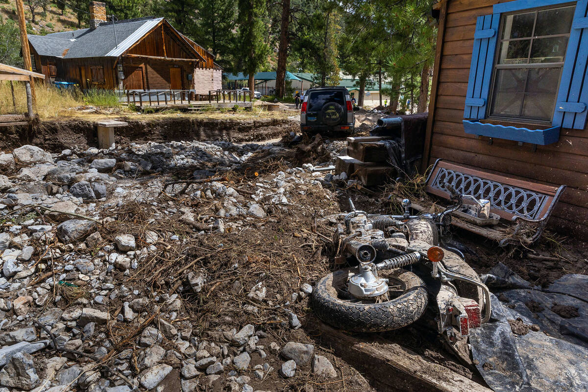 A motorcycle from Old Town residents Katie and Sean Reeh is covered in debris on their property ...