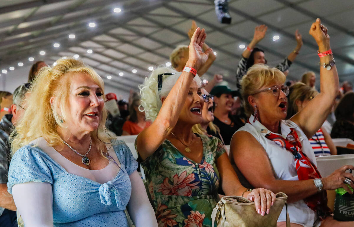 From left, Susan Shutt, Dovett Elliot and Marry Kay Bachman cheer on Mark Sherwood, minister an ...