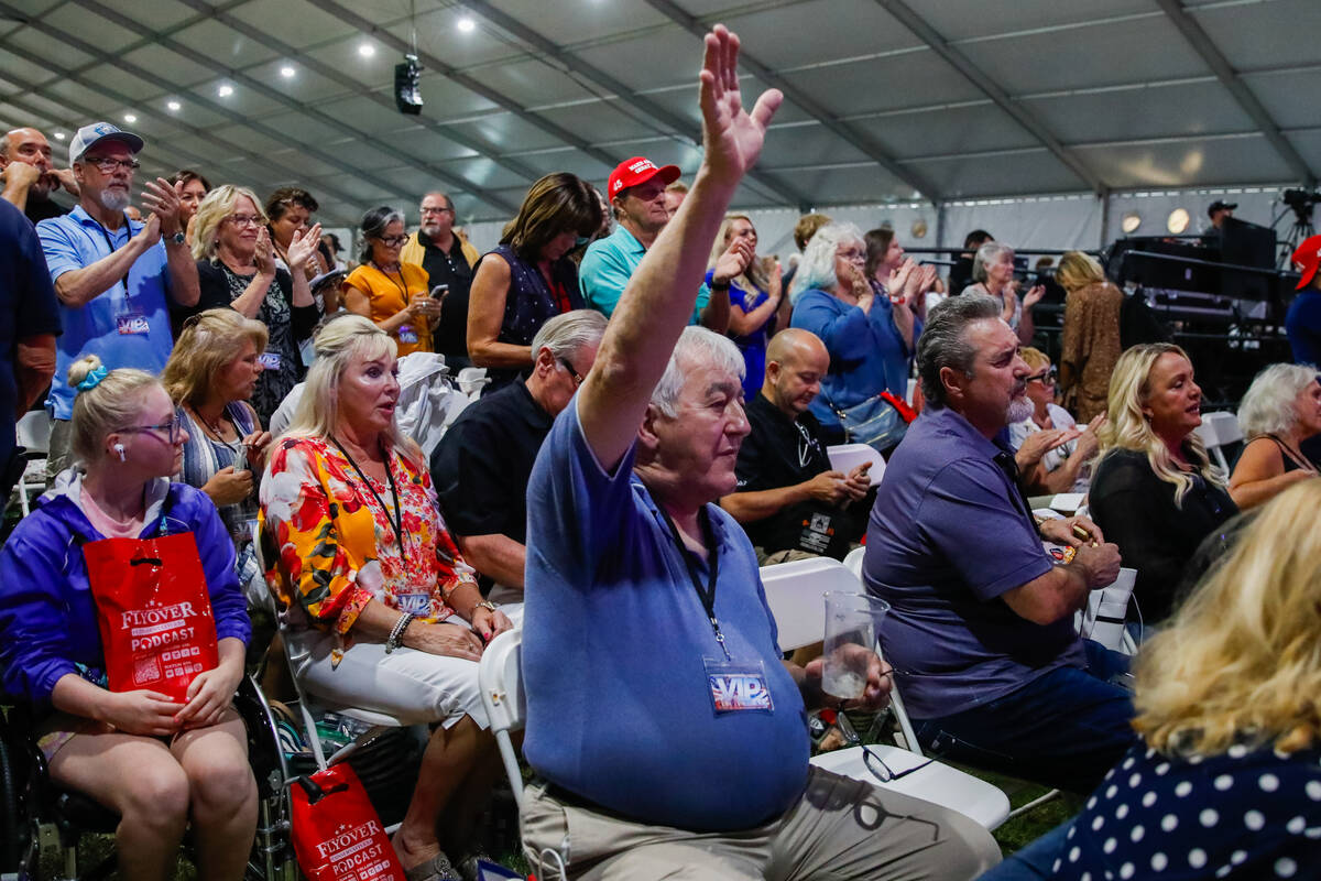 Crowds of people watch Michael J. Lindell, CEO of My Pillow, speak at the ReAwaken America Tour ...