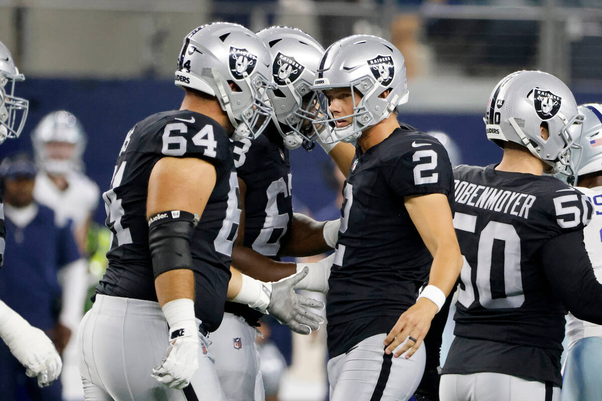 Las Vegas Raiders guard Alex Bars (64) and place kicker Daniel Carlson (2) celebrate after Carl ...