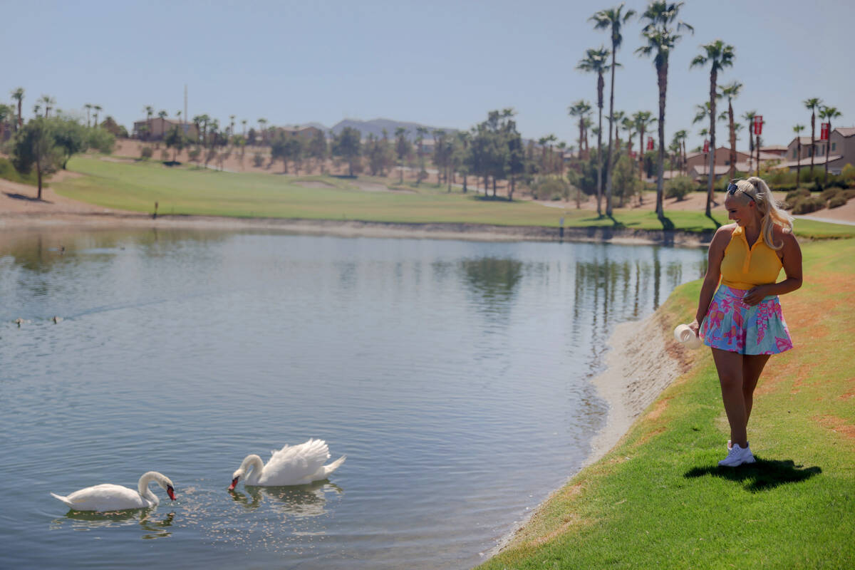 Cass Holland, a cart girl with a massive Tik Tok following, feeds the swans at Chimera Golf Clu ...