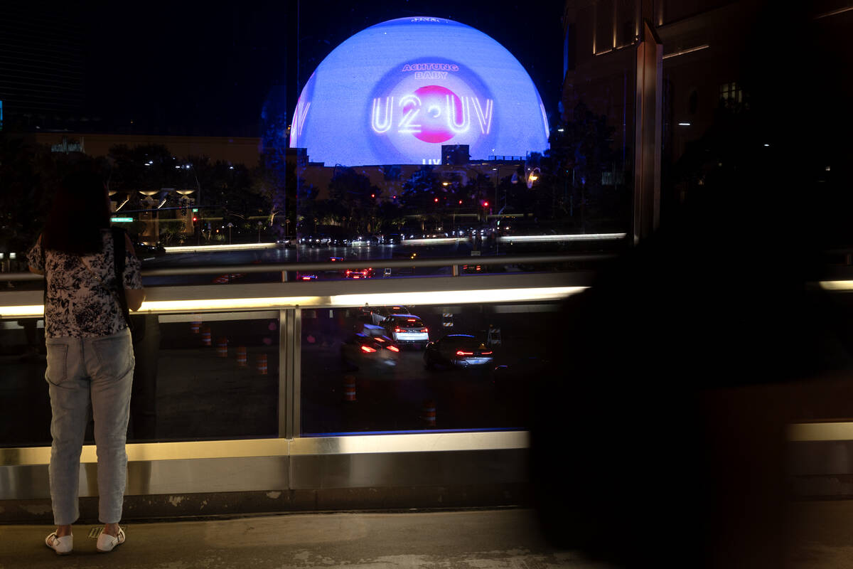 Visitors to the Las Vegas Strip view The Sphere on the pedestrian bridge over Sands Avenue betw ...