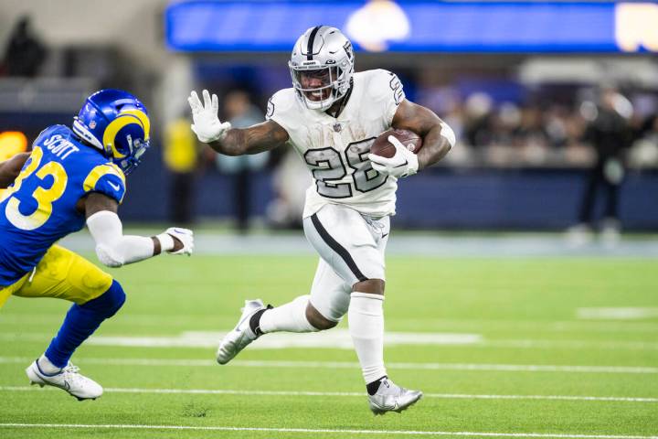 Las Vegas Raiders running back Josh Jacobs (28) runs with the ball during an NFL football game ...