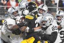 Pittsburgh Steelers running back Najee Harris (22) is gang tackled during the first half of an ...